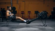 A man exercising on one of the best rowing machines