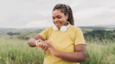 A woman checking one of the best fitness trackers during workout